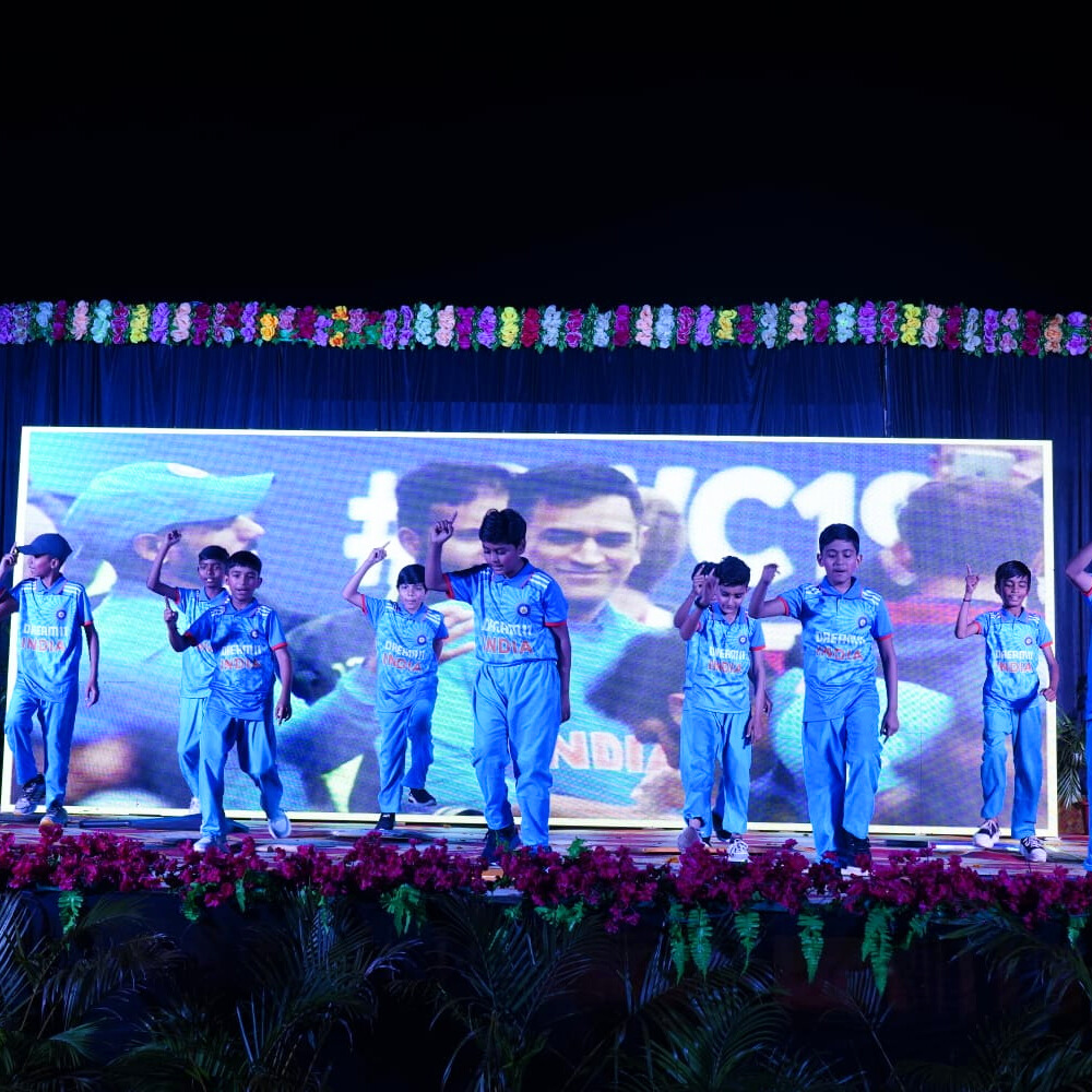 Students performing musical pieces on stage with a live audience at the school music concert.